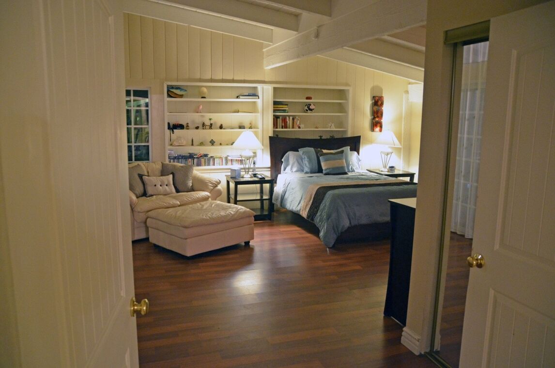 bedroom with wooden floor and vaulted ceiling