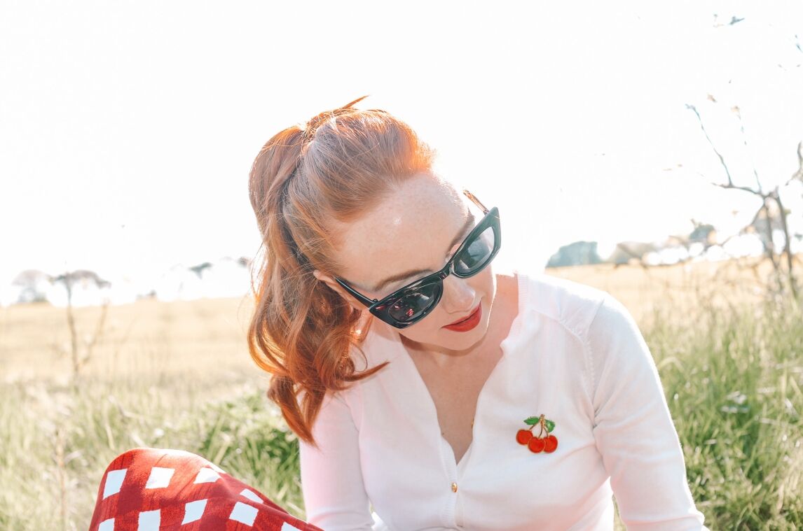 retro-inspired outfit featuring red gingham circle skirt and cherry cardigan