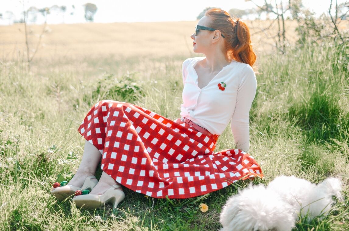 retro-inspired outfit featuring red gingham circle skirt and cherry cardigan