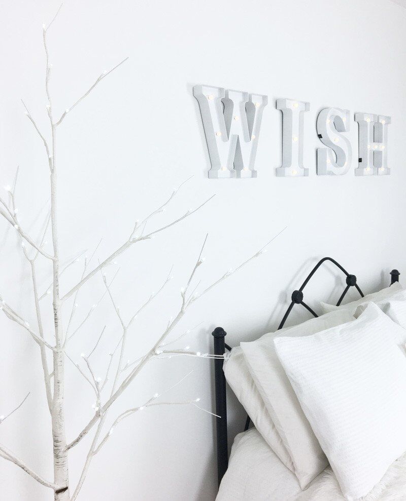 LED letter lights in all-white bedroom