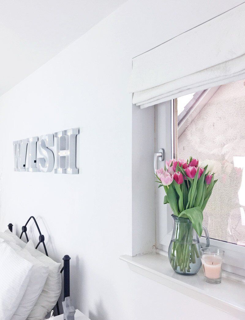 LED letter lights in all-white bedroom