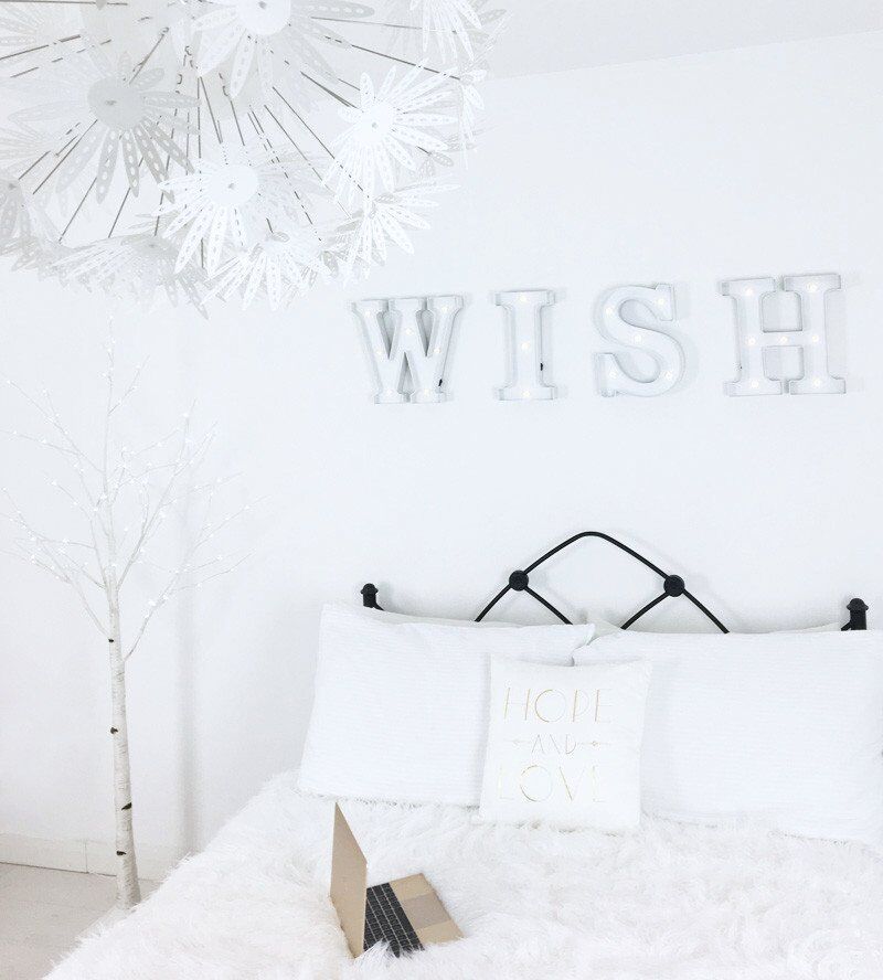 all-white bedroom with white LED tree light and WISH sign