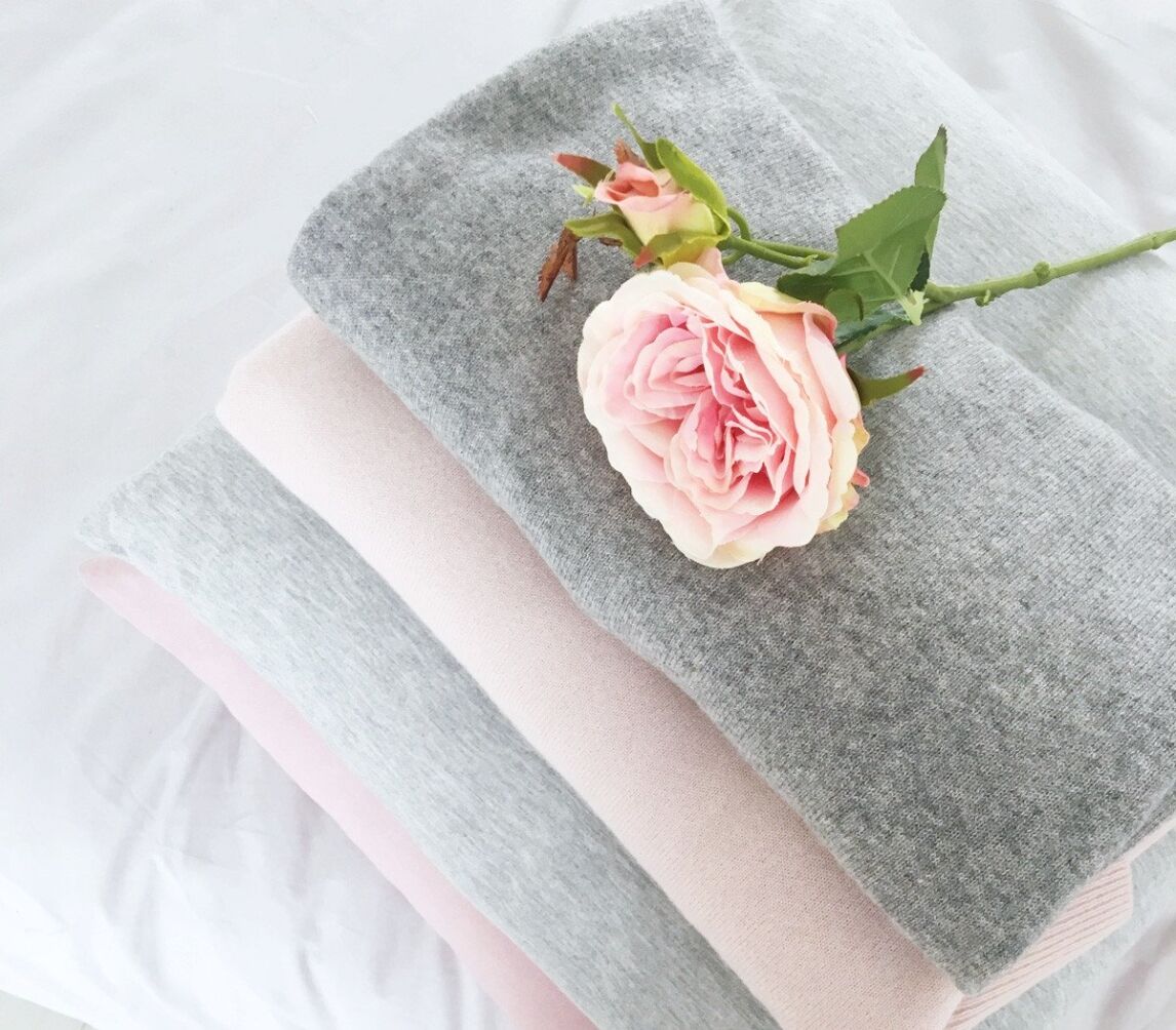 pink rose on grey sweater
