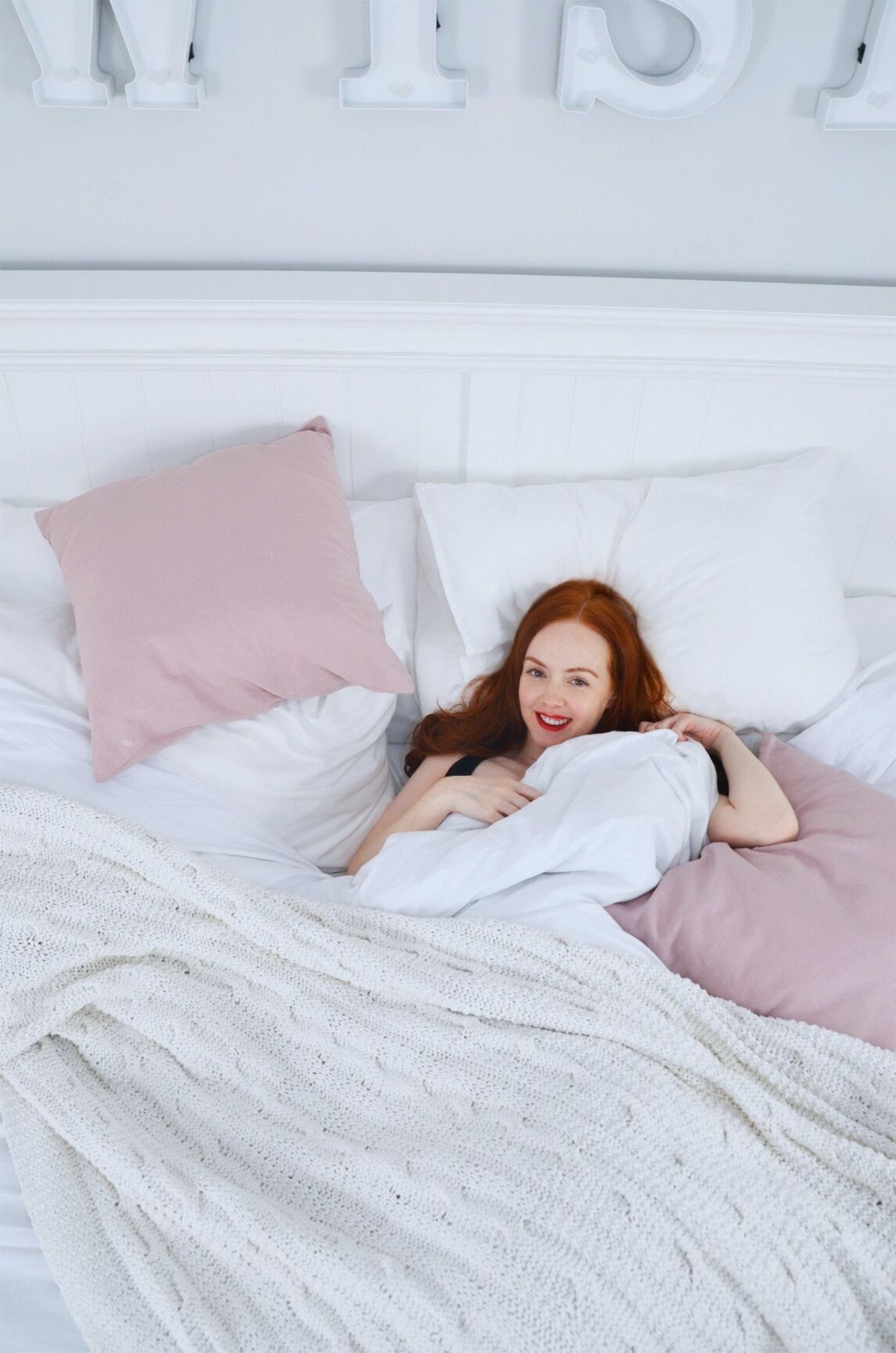 pink and white bedsheets on New England Superking bed