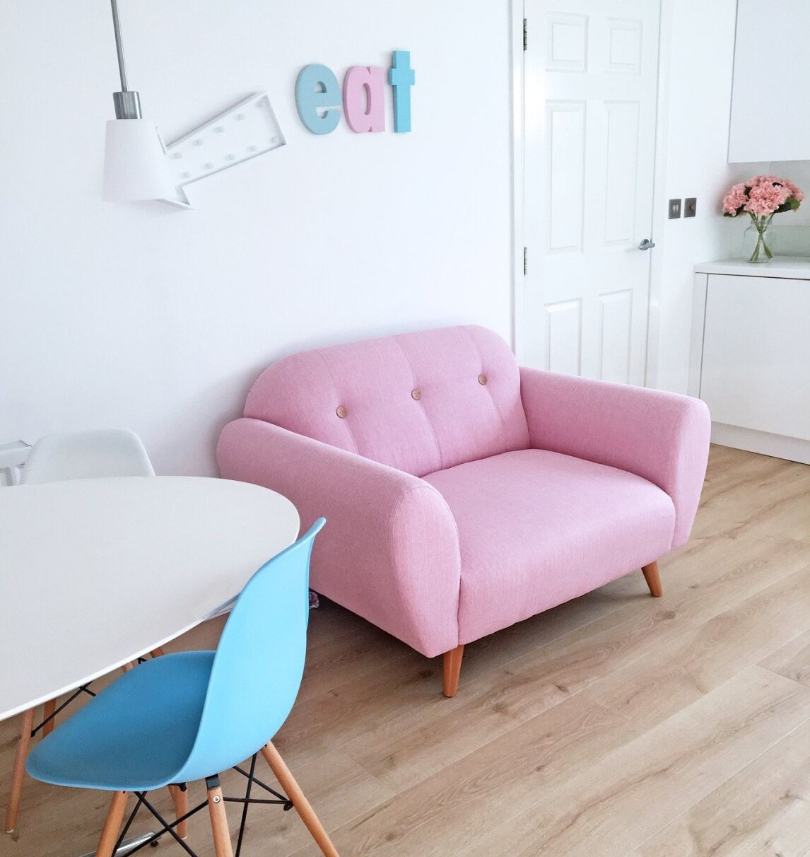 DFS Betsey pink two seater sofa in all-white kicthen