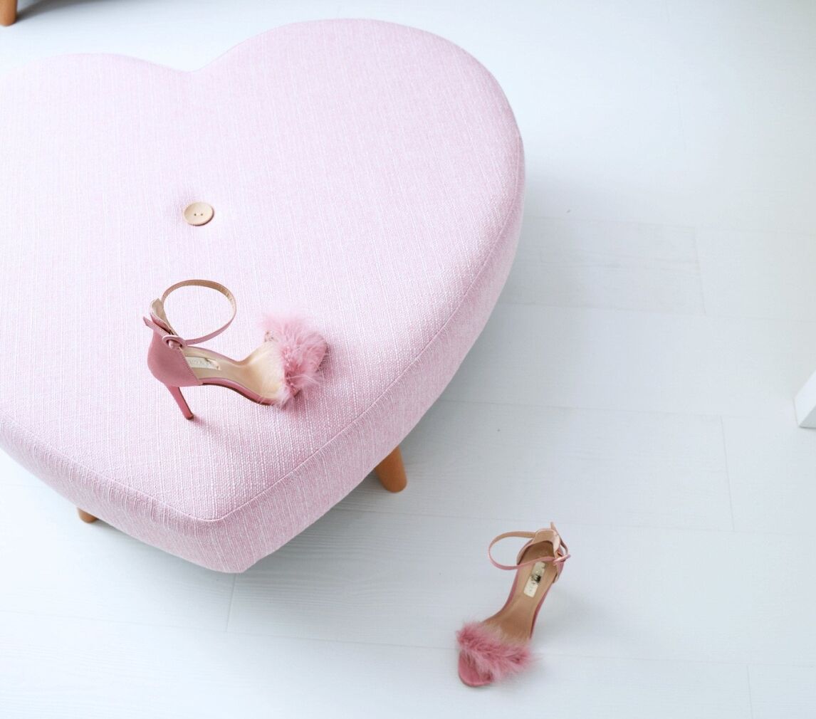 pink heart-shaped stool on white floorboards
