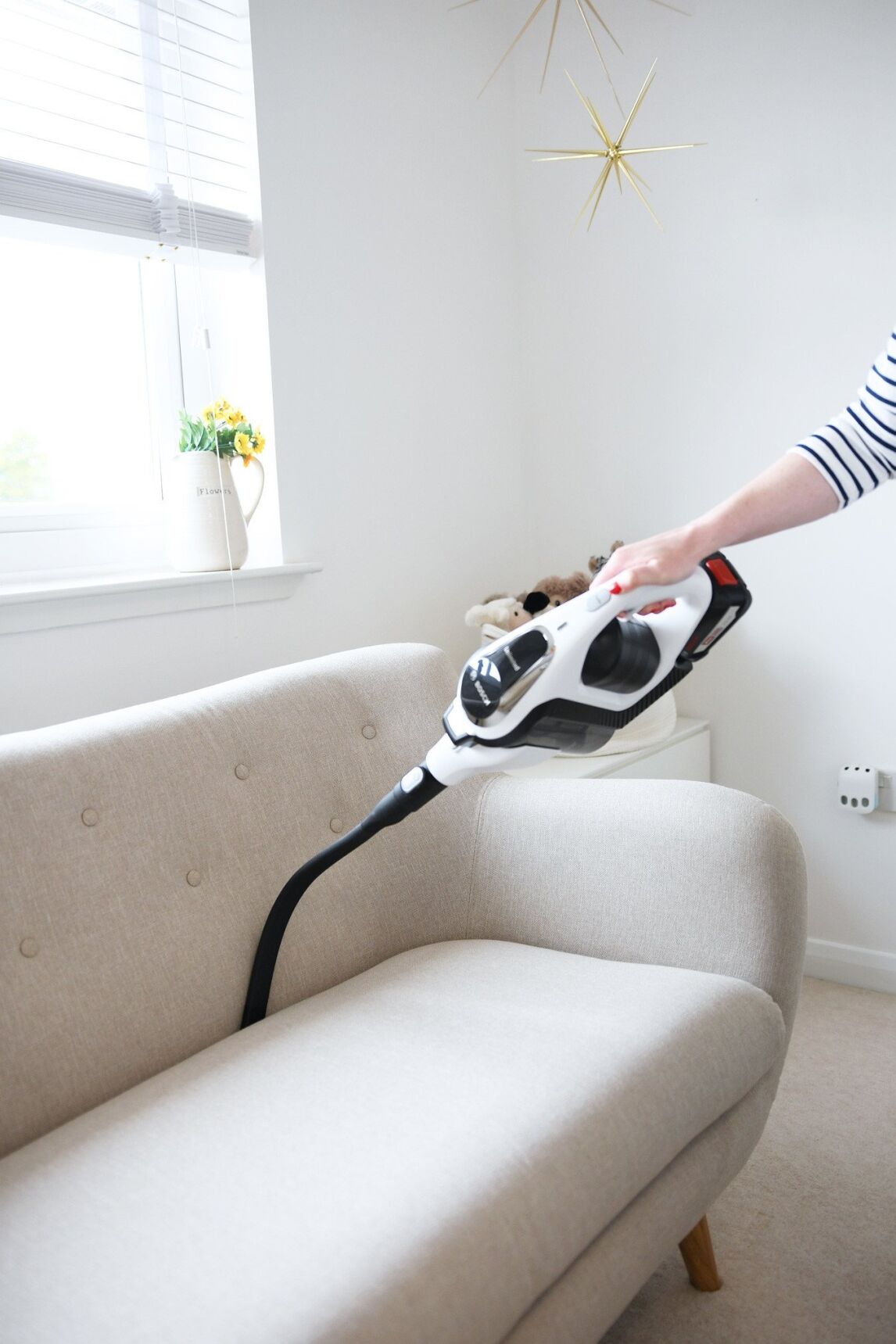 cleaning behind the sofa