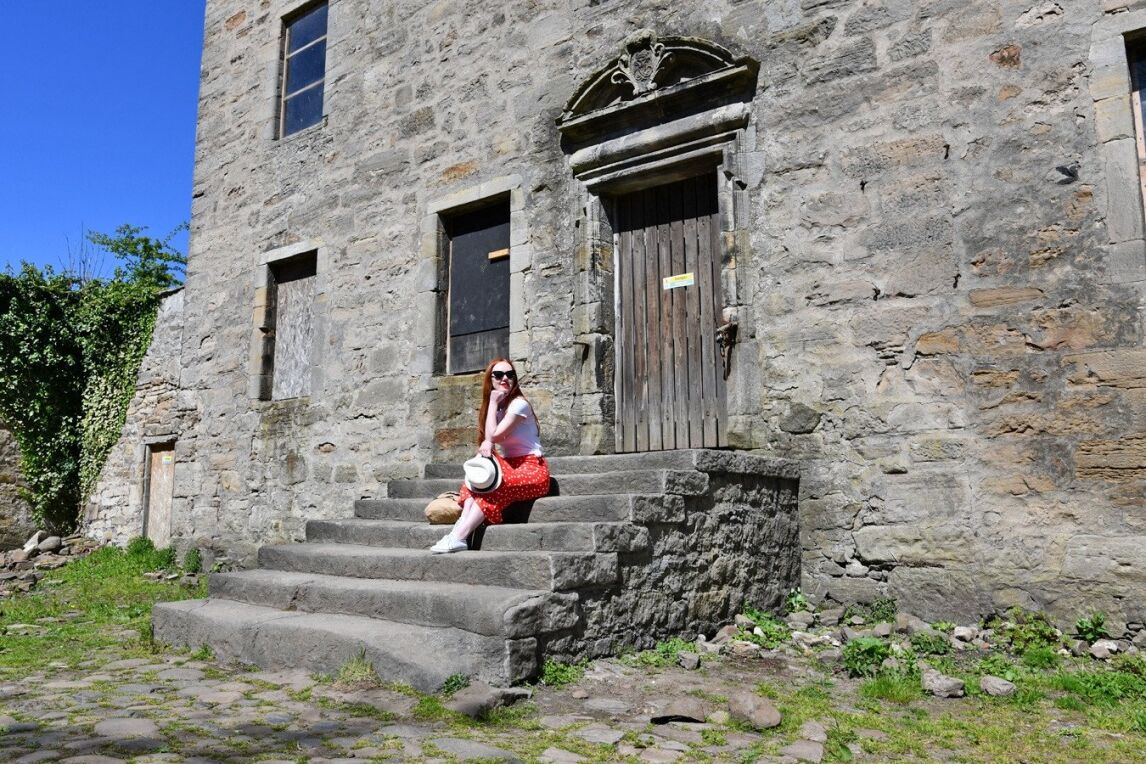 On the steps at Lallybroch - a.k.a Midhope Castle - an Outlander filming location in Scotland