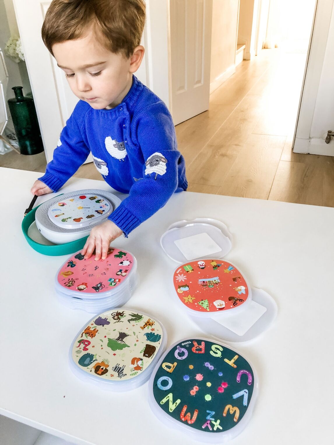 Max playing with his TIMIO device: a screen-free kids music player