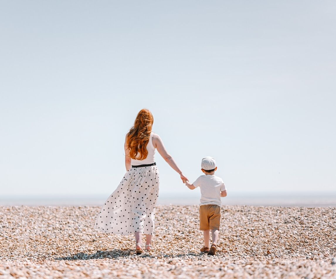 Amber and Max on a pebble beach