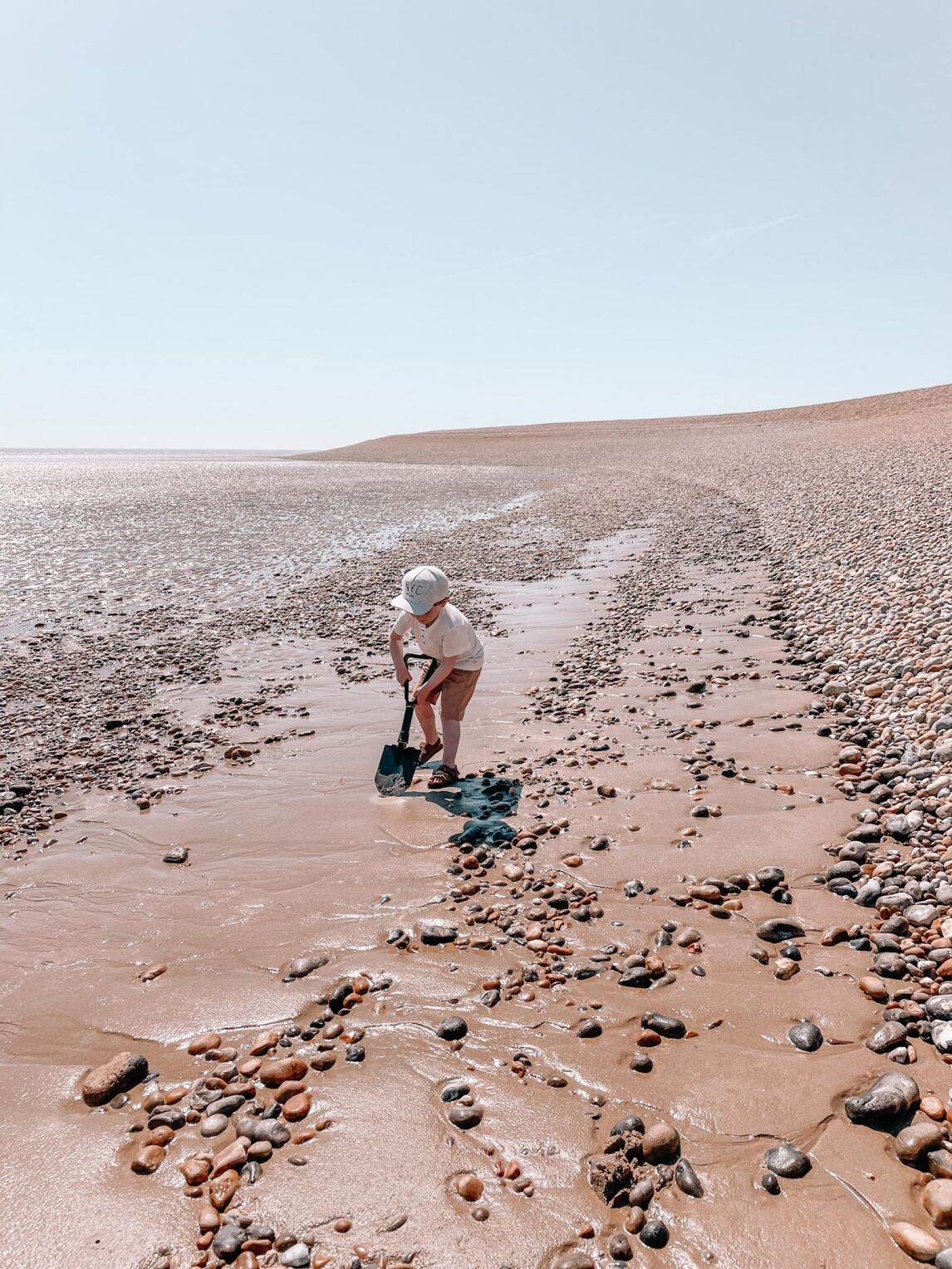Max digging in the sand on Dungeness Beach, Kent