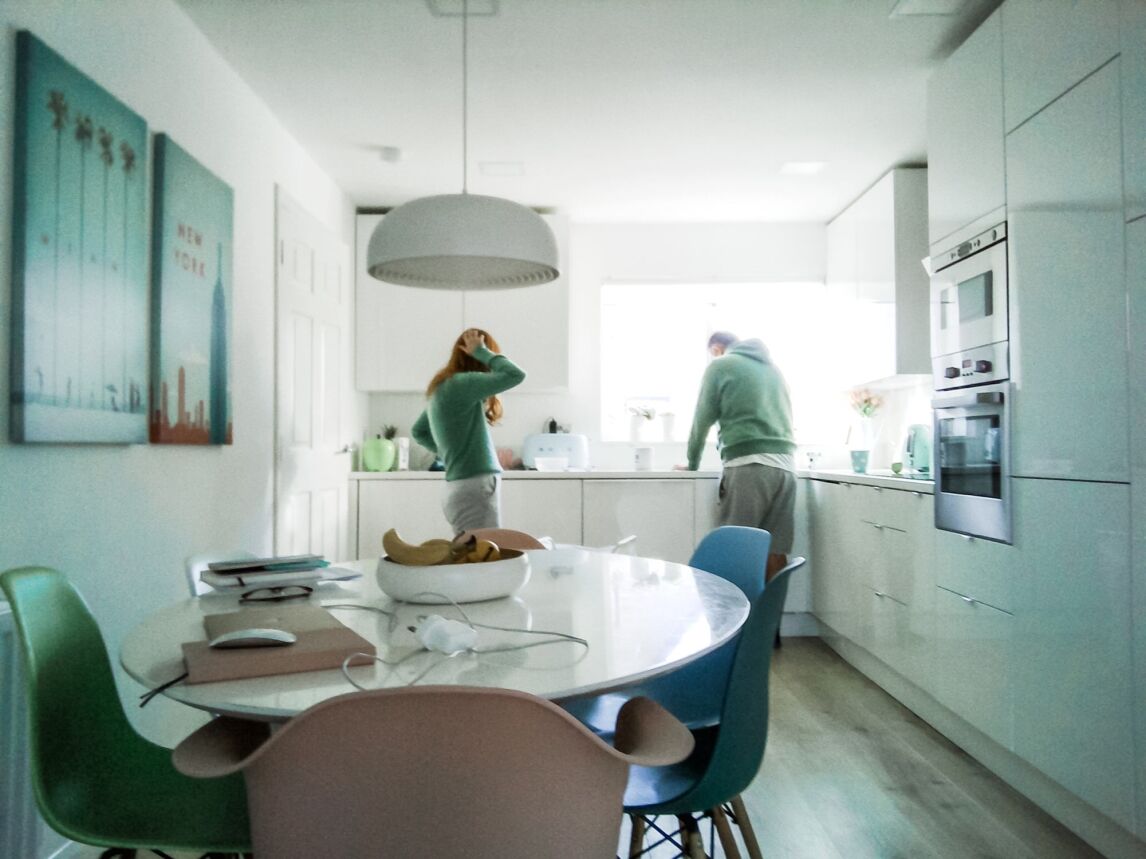 Amber and Terry talking in the kitchen of their house